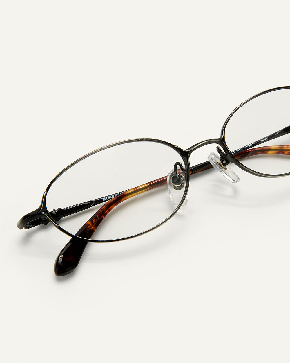 Close up shot of Bonnie Clyde Bunny eyeglasses in black tortoise frames with clear lenses.