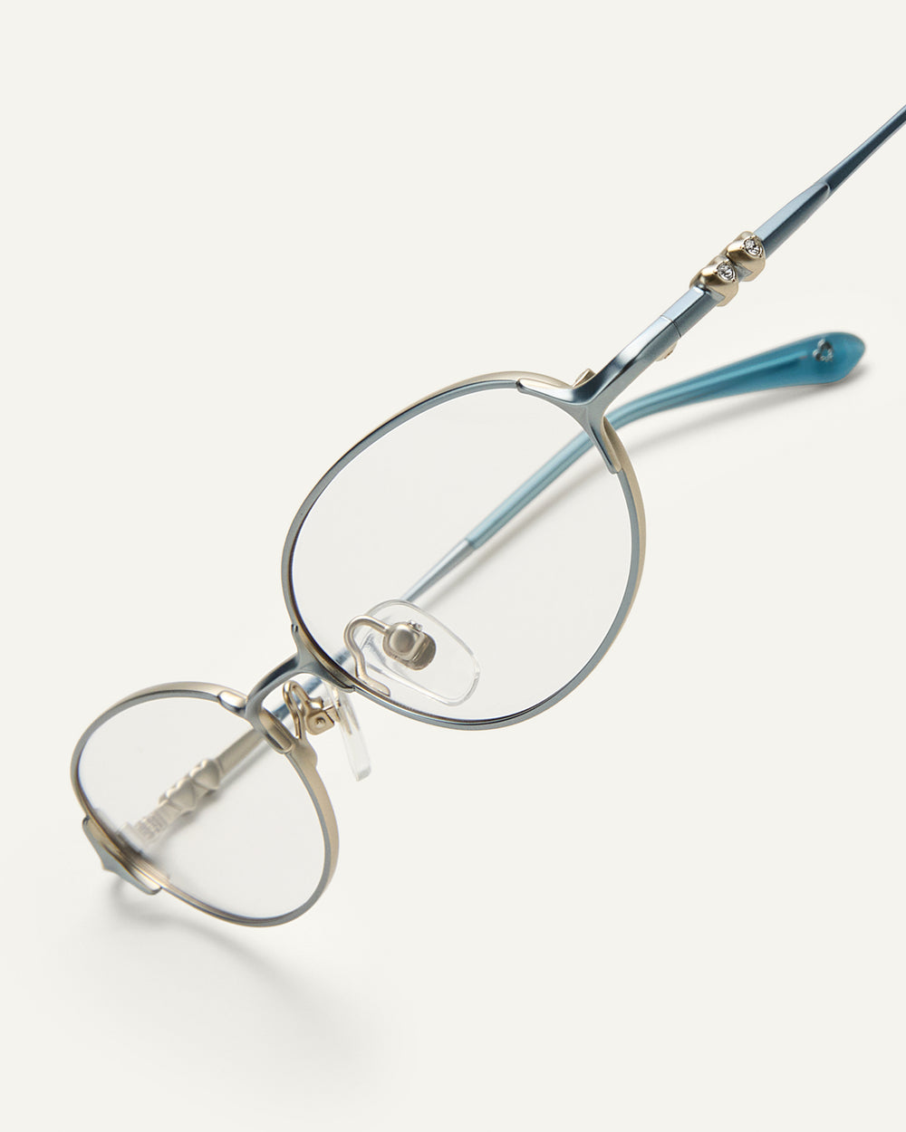 Side shot of Bonnie Clyde Bunny eyeglasses in titanium silver with teal acetate and clear lenses. 