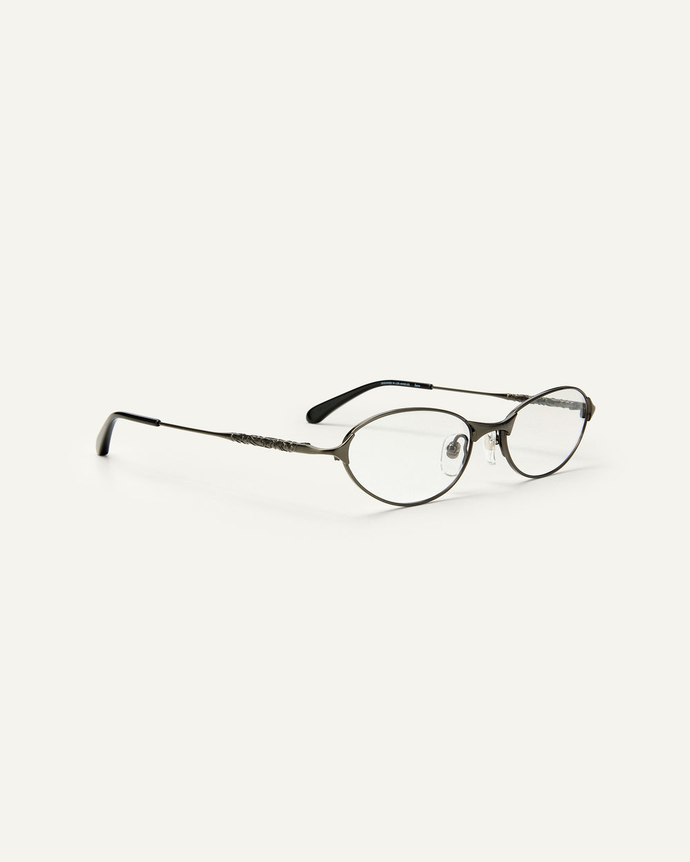 Quarter shot of Bonnie Clyde Intro eyeglasses in gunmetal titanium frames with black acetate details and clear lenses.
