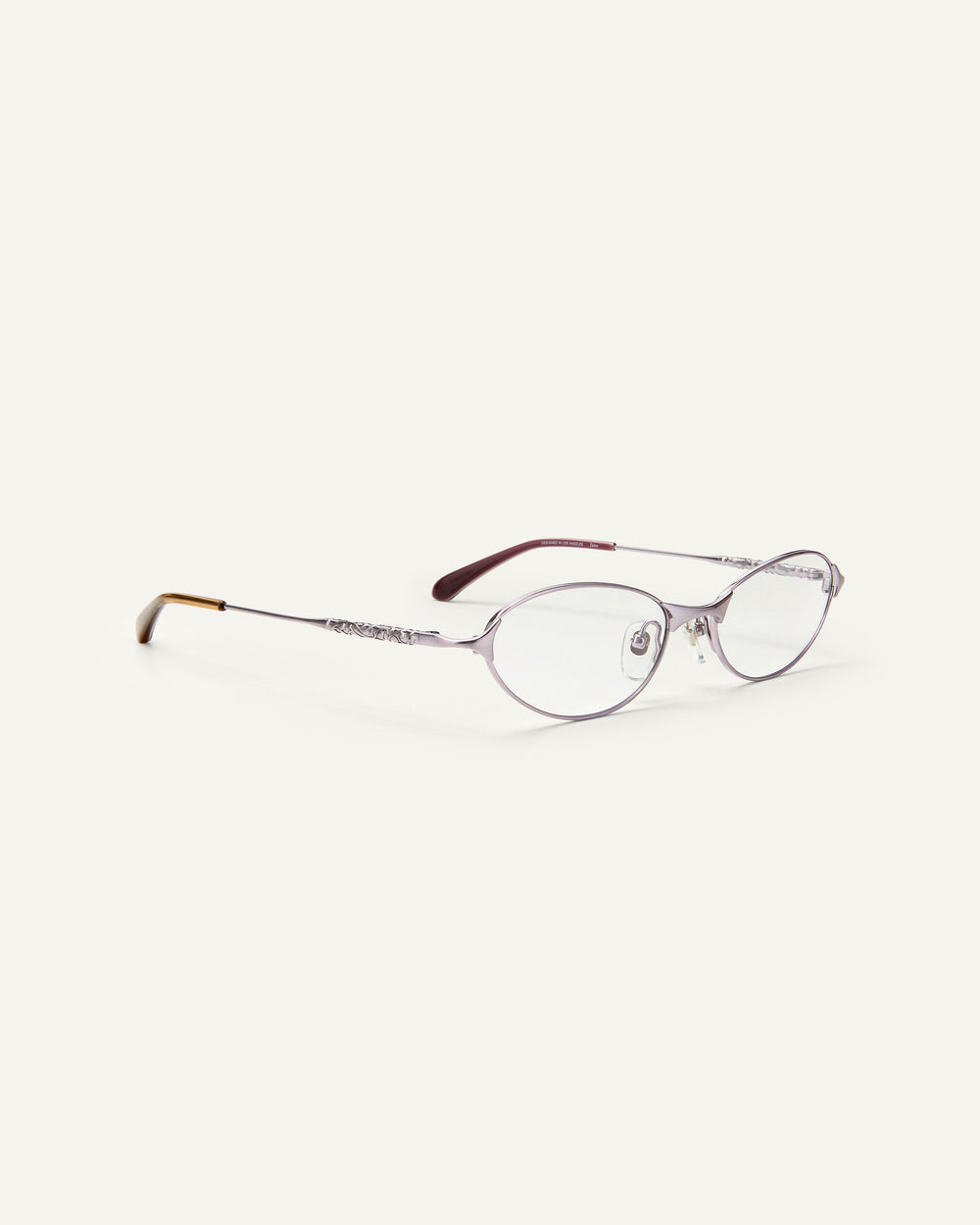 Quarter shot of Bonnie Clyde Intro eyeglasses in purple titanium frames with dark purple acetate details and clear lenses.