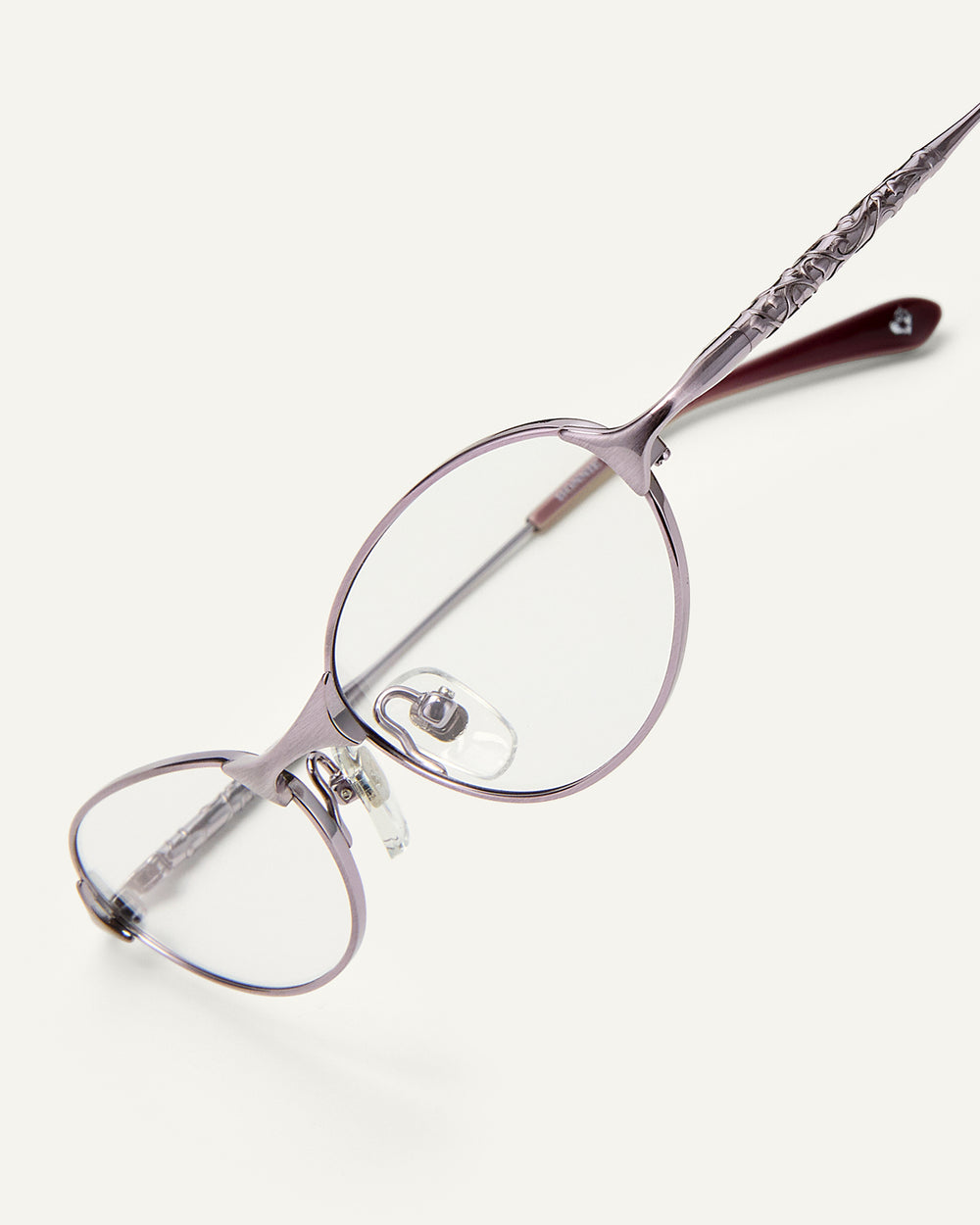Side shot of Bonnie Clyde Intro eyeglasses in purple titanium frames with dark purple acetate details and clear lenses.