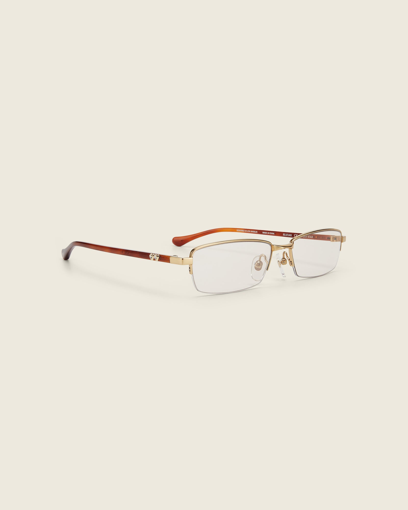 Bonnie Clyde Lucky Star Glasses. Gold frames with clear lenses and tortoise arm temples.