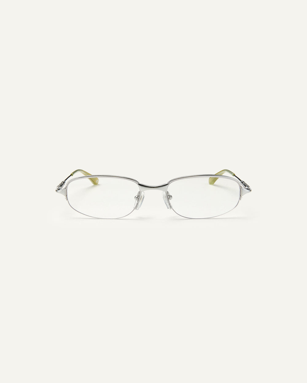 Face shot of Bonnie Clyde Outro eyeglasses in silver titanium frames with green acetate details and clear lenses.