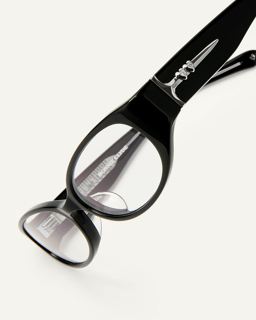 Side shot of Bonnie Clyde Precious eyeglasses in black frames with clear lenses.