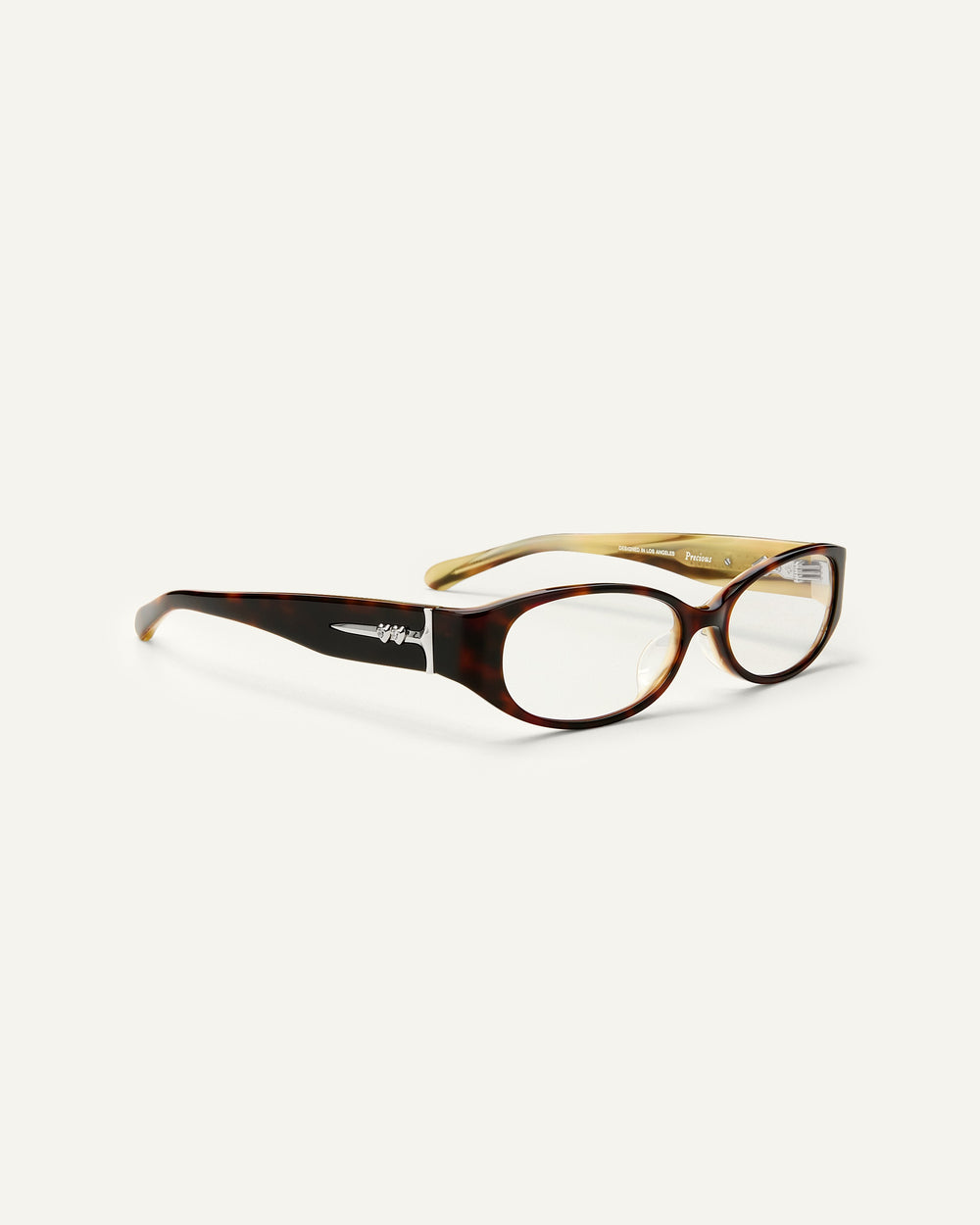 Quarter shot of Bonnie Clyde Precious eyeglass in layered tortoise frames with clear lenses.